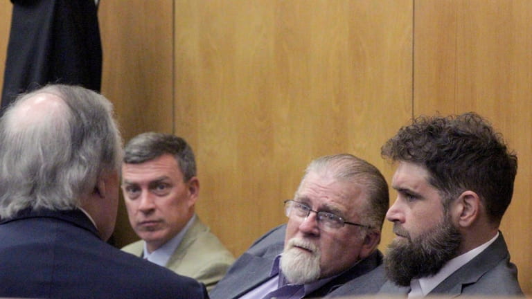 Gregory Case, the father, center, and Brandon Case, the son,...