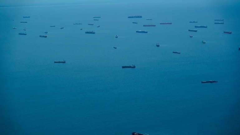 Cargo ships wait in Panama Bay before moving through the...