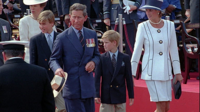 Prince Charles and Princess Diana escort their children William, left,...