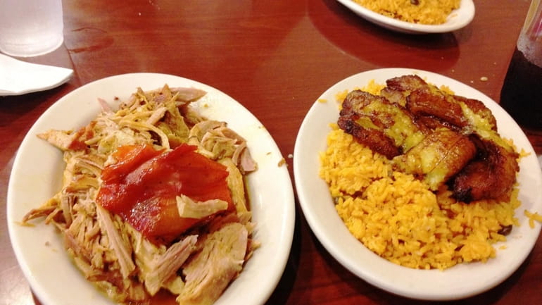 The pernil (pork) and rice with fried sweet plantains at...