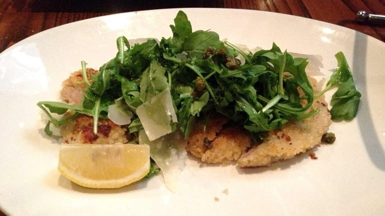Veal Milanese topped with arugula, Parmesan and capers is one...