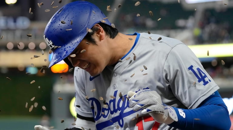 Los Angeles Dodgers designated hitter Shohei Ohtani (17) is doused...