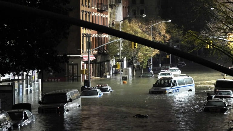 A view of submerged cars on Avenue C and East...