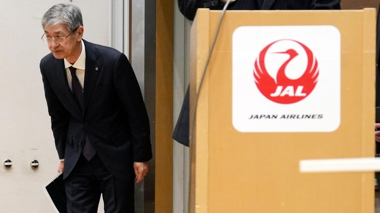 Yuji Akasaka, President and CEO of Japan Airlines bows to...