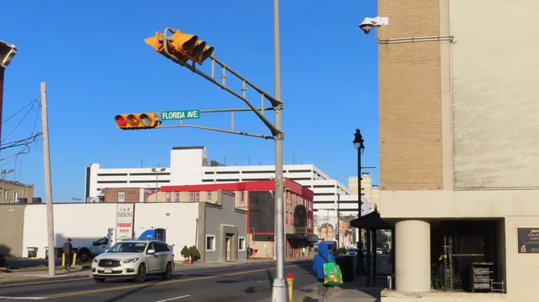 A building-mounted security camera faces down on Florida Avenue in...