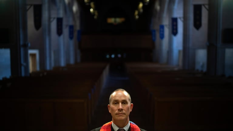 Rev. Stephen Cady stands for a portrait in the sanctuary...
