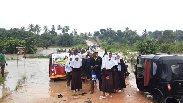 Schoolchildren stranded on a damaged River Zingiziwa bridge in Dar...