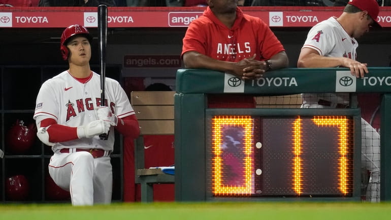 Los Angeles Angels DH Shohei Ohtani stands near the pitch clock...