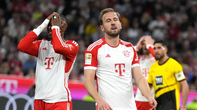 Bayern's Mathys Tel, left, and Bayern's Harry Kane react during...