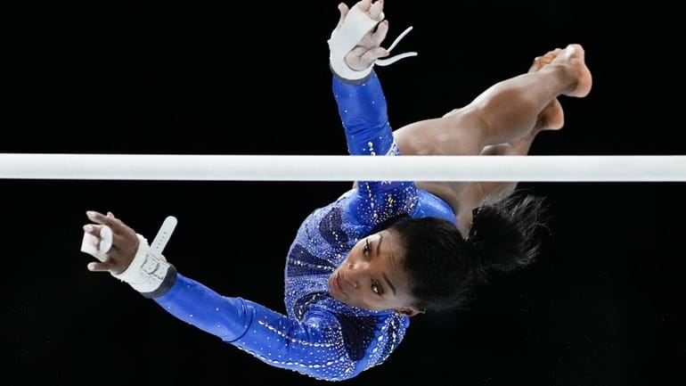 United States' Simone Biles competes on the uneven bars during...