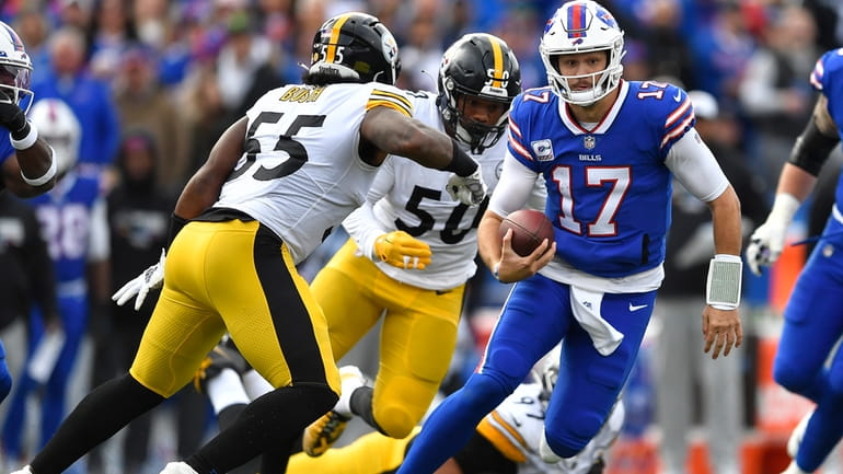 Buffalo Bills quarterback Josh Allen (17) scrambles with Pittsburgh Steelers...