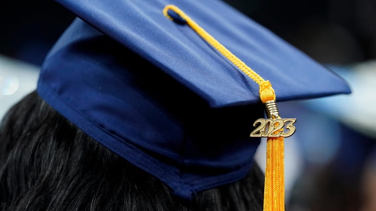 A tassel with 2023 on it rests on a graduation...