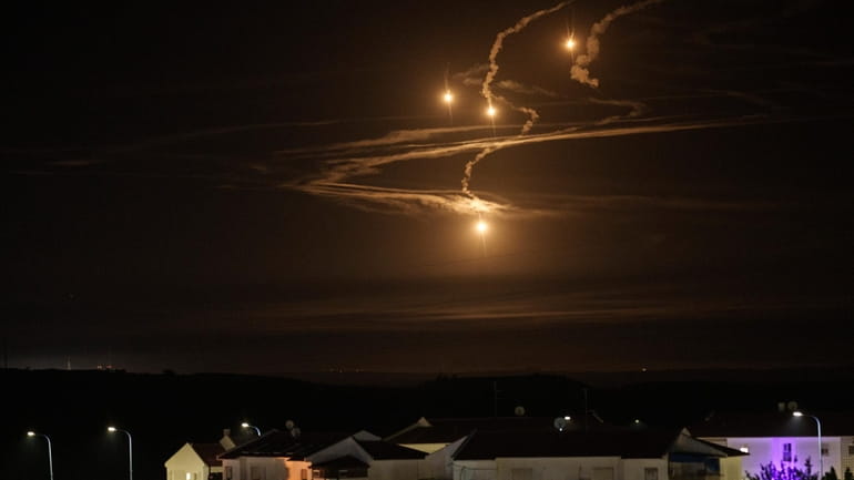 Flares rise over the Gaza Strip as seen from southern...