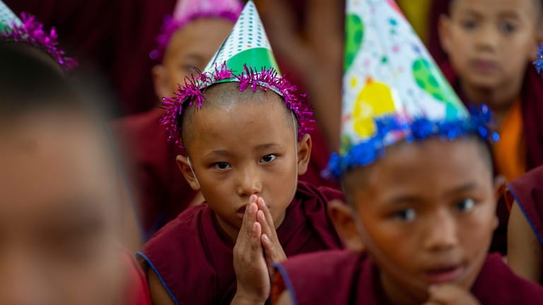 Young monks offer prayers during celebrations to mark the birthday...