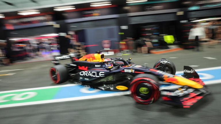 Red Bull driver Max Verstappen of the Netherlands leaves pits...