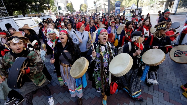 Women drummers sing as they lead a march during an...