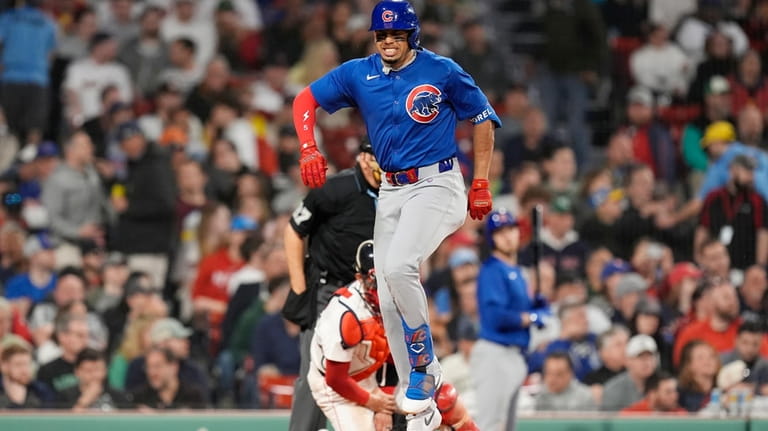 Chicago Cubs' Christopher Morel reacts after fouling off his foot...