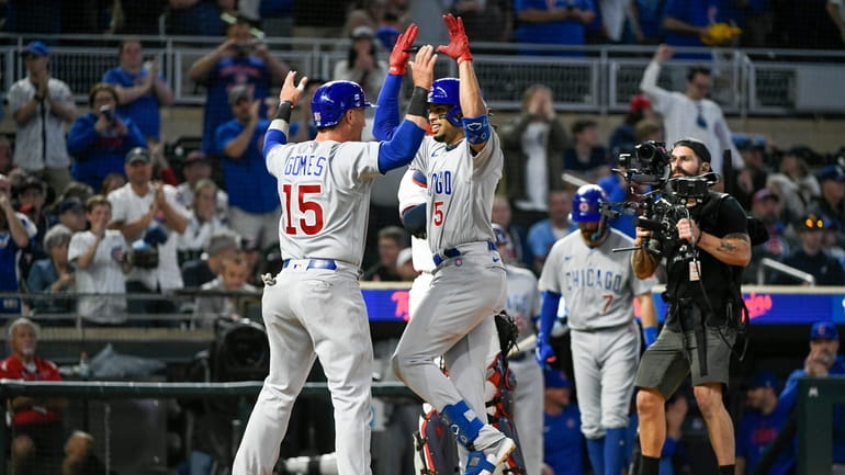 Chicago Cubs' Christopher Morel (5) celebrates with teammate Yan Gomes...