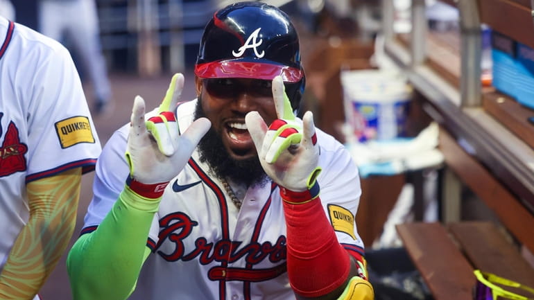 Atlanta Braves' Marcell Ozuna celebrates after hitting a solo home...
