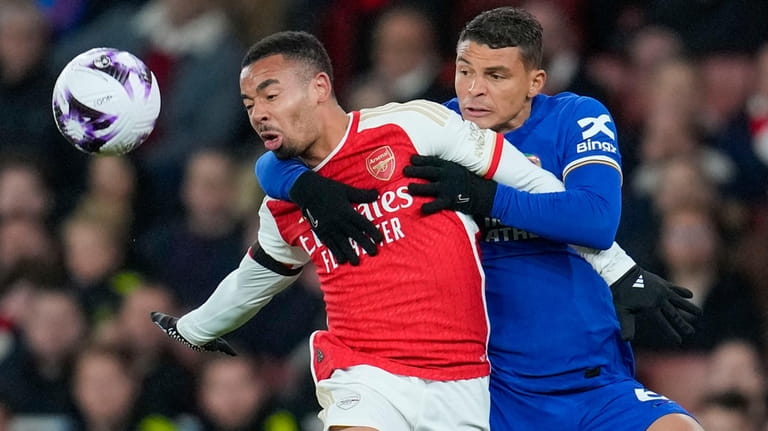 Arsenal's Gabriel Jesus, left, duels for the ball with Chelsea's...