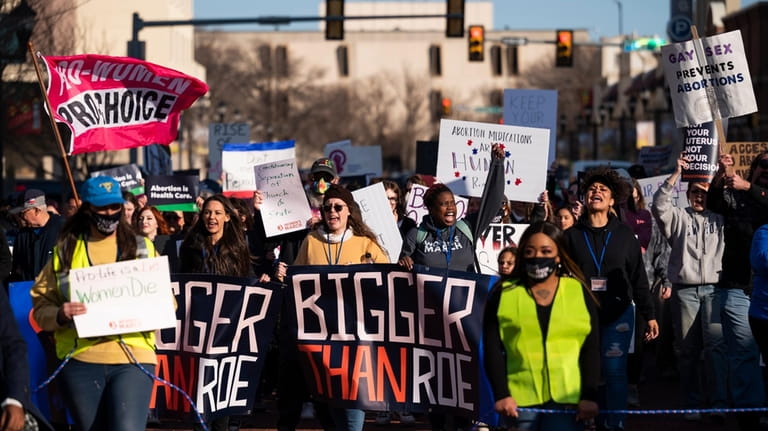 People march through downtown Amarillo to protest a lawsuit to...