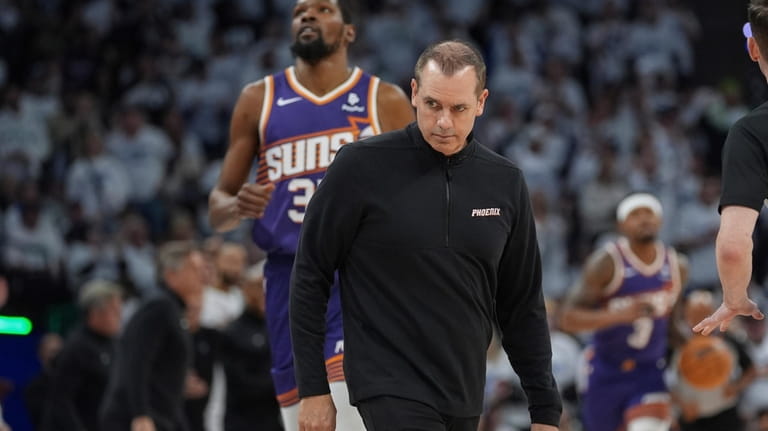 Phoenix Suns head coach Frank Vogel stands on the court...
