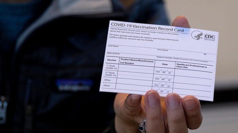 A COVID-19 vaccine card at a New York Health and...