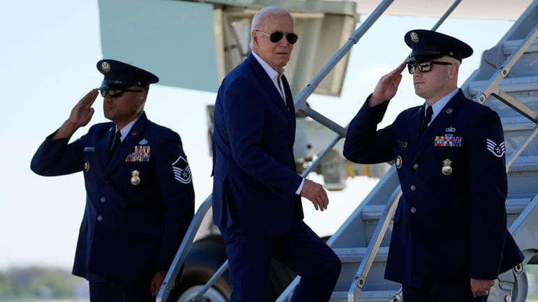 President Joe Biden boards Air Force One as he departs...