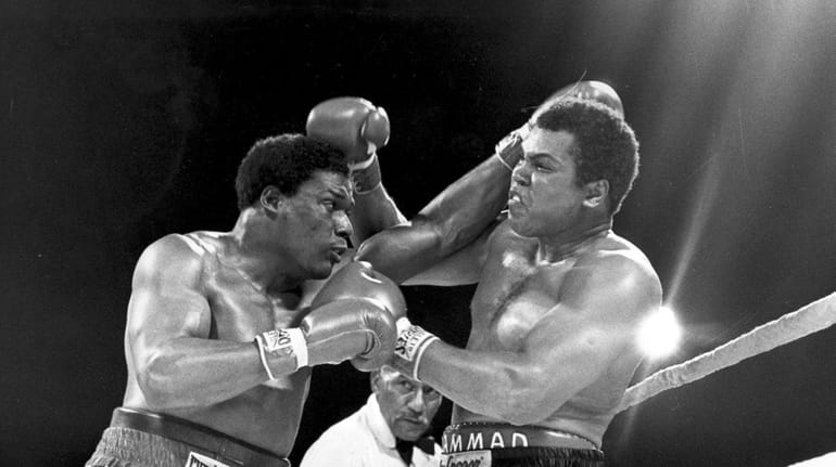 Muhammad Ali, right, takes a punch from Trevor Berbick on...