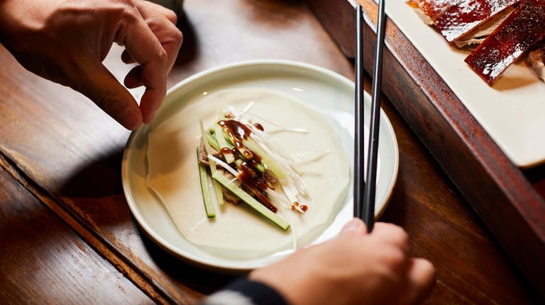 Peking duck served with slivered cucumber, scallions, and hoisin sauce...