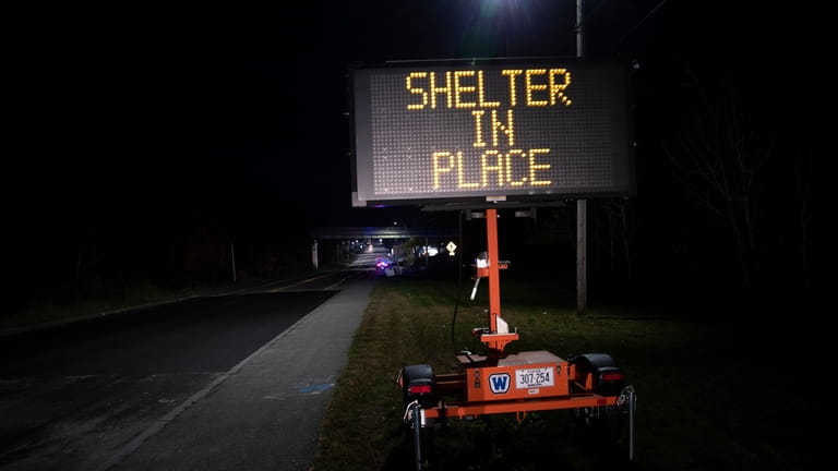 A sign signals the public to shelter in place during...