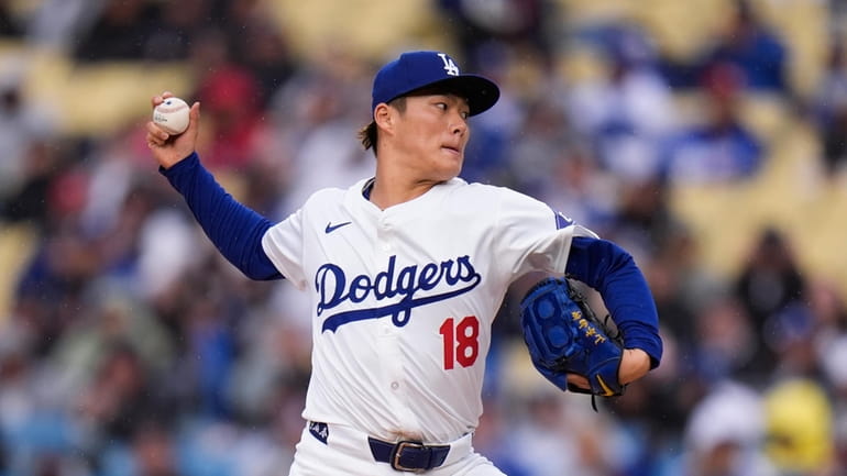 Los Angeles Dodgers starting pitcher Yoshinobu Yamamoto throws against the...