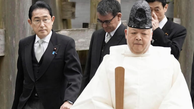 FILE - Japan's Prime Minister Fumio Kishida, left, visits Ise...