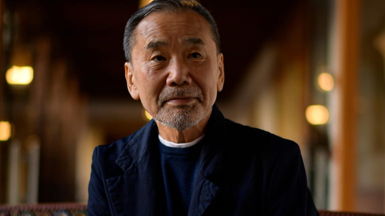 Japanese author Haruki Murakami poses ahead of an interview with...