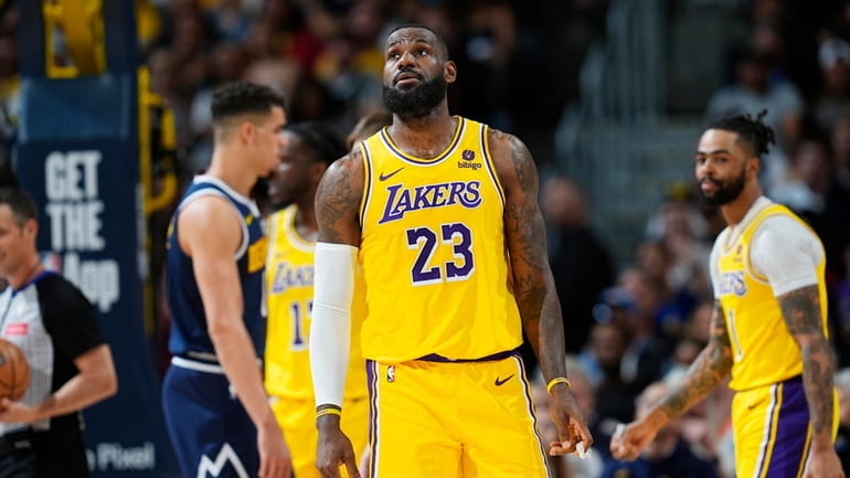 Los Angeles Lakers forward LeBron James (23) checks the scoreboard...
