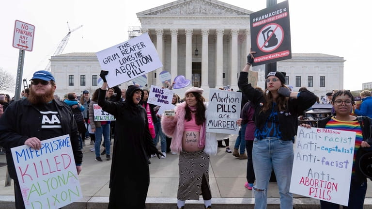 Anti-Abortion demonstrators protest outside of the Supreme Court during a...