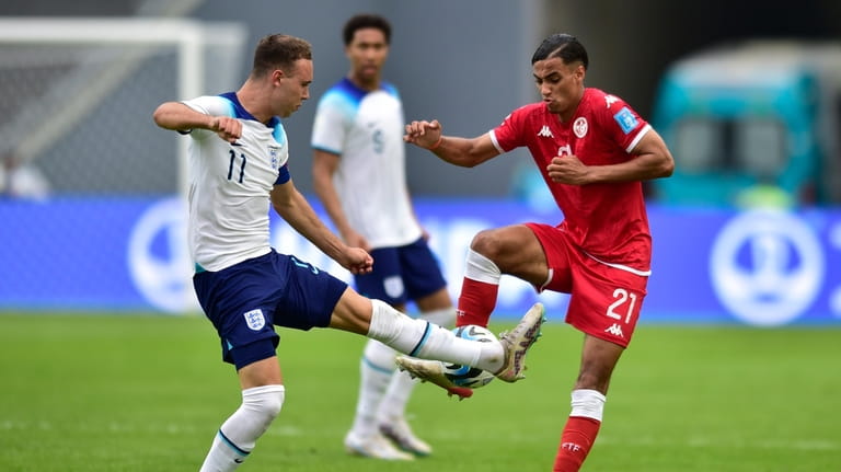 England's Harvey Vale, left, and Tunisia's Jebril Othman fights for...