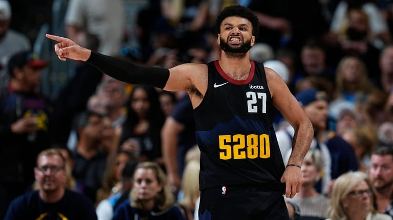 Denver Nuggets guard Jamal Murray reacts after not getting a...