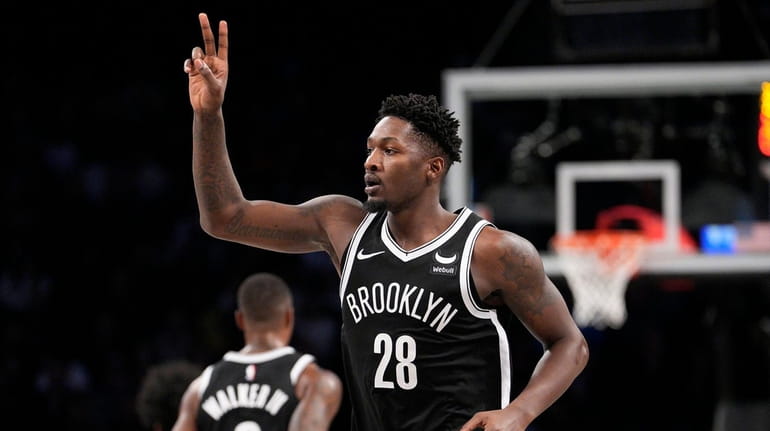 Dorian Finney-Smith of the Nets makes a three-pointer during a...