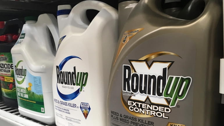In this Feb. 24, 2019, file photo, containers of Roundup...