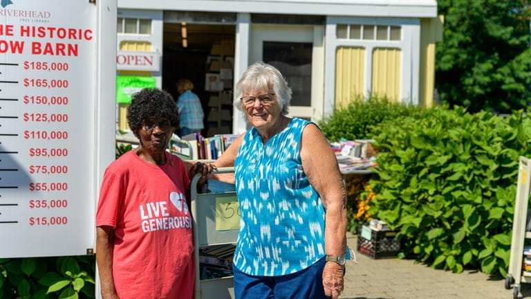 Friends of the Riverhead Free Library volunteers Sarah Mayo, left,...