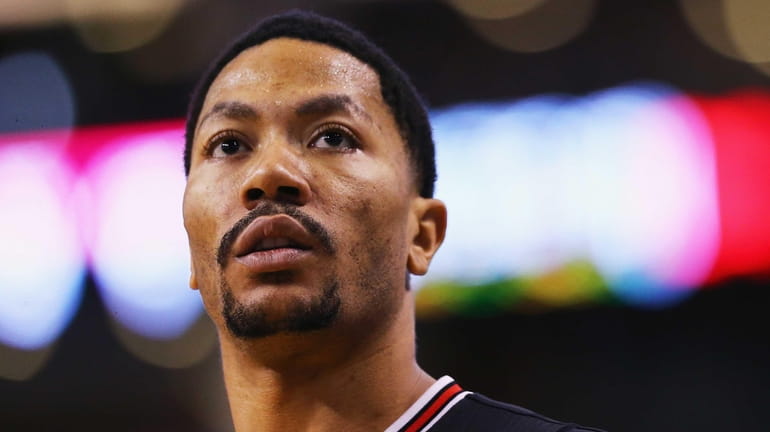 Derrick Rose #1 of the Chicago Bulls looks on during...