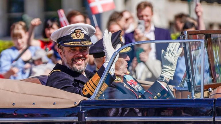 King Frederik of Denmark, left, and Norway's King Harald wave...