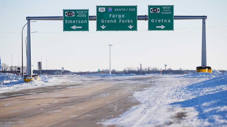 Road signage is posted just outside of Emerson, Manitoba on...