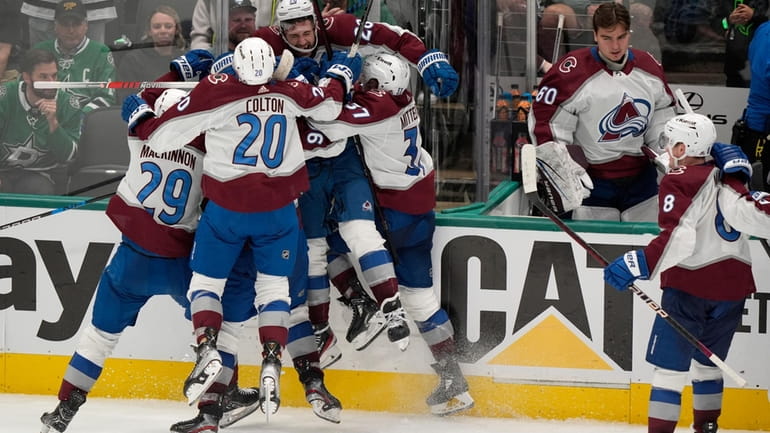 Colorado Avalanche left wing Miles Wood (28) is lifted off...