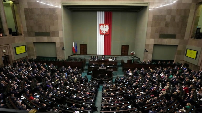 Newly elected Poland's Prime Minister Donald Tusk addresses lawmakers during...