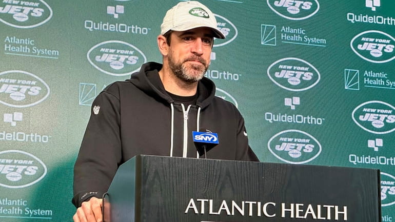 New York Jets quarterback Aaron Rodgers speaks to reporters at...