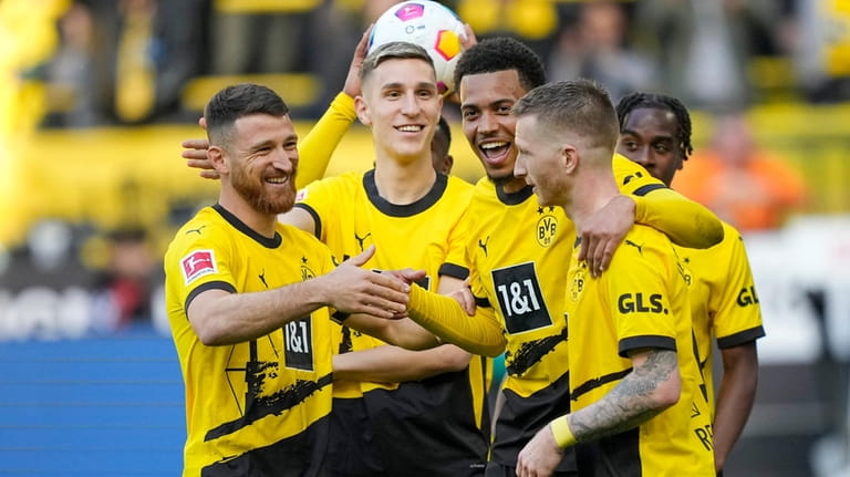 Dortmund's Felix Nmecha, second from right, celebrates with his teammates...