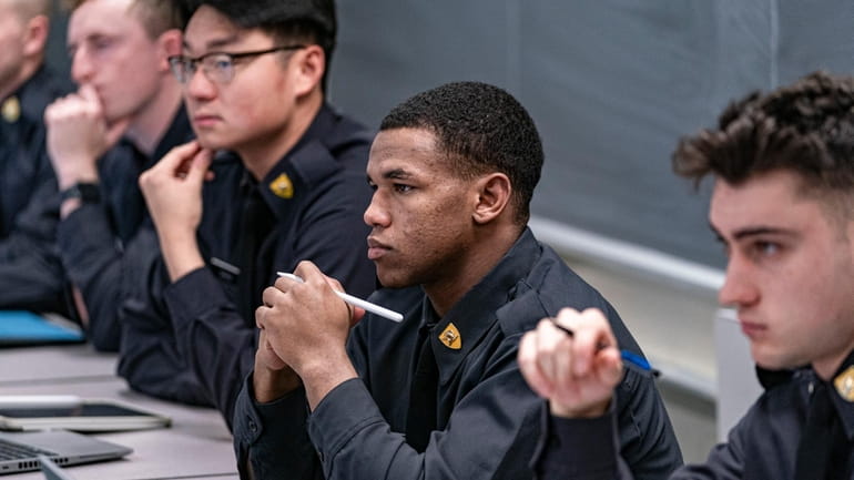 Cadets participate in a class on American politics at the...