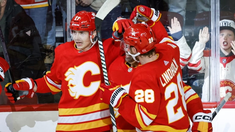 Calgary Flames forward Yegor Sharangovich (17) celebrates his overtime goal...
